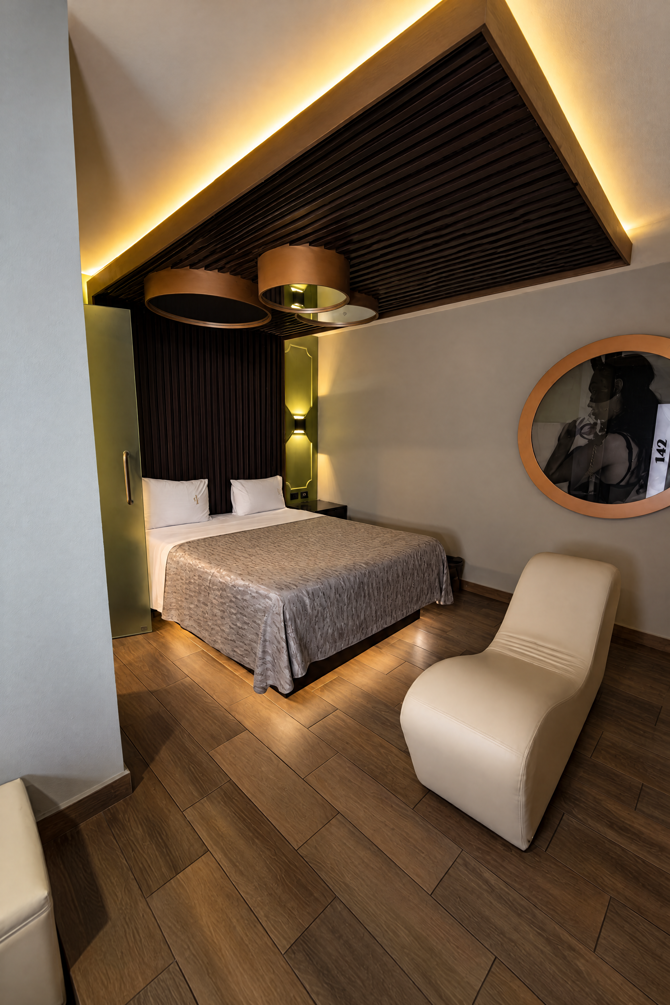 Vista de habitación de Mediterráneo con cama, sillón y espejo circular