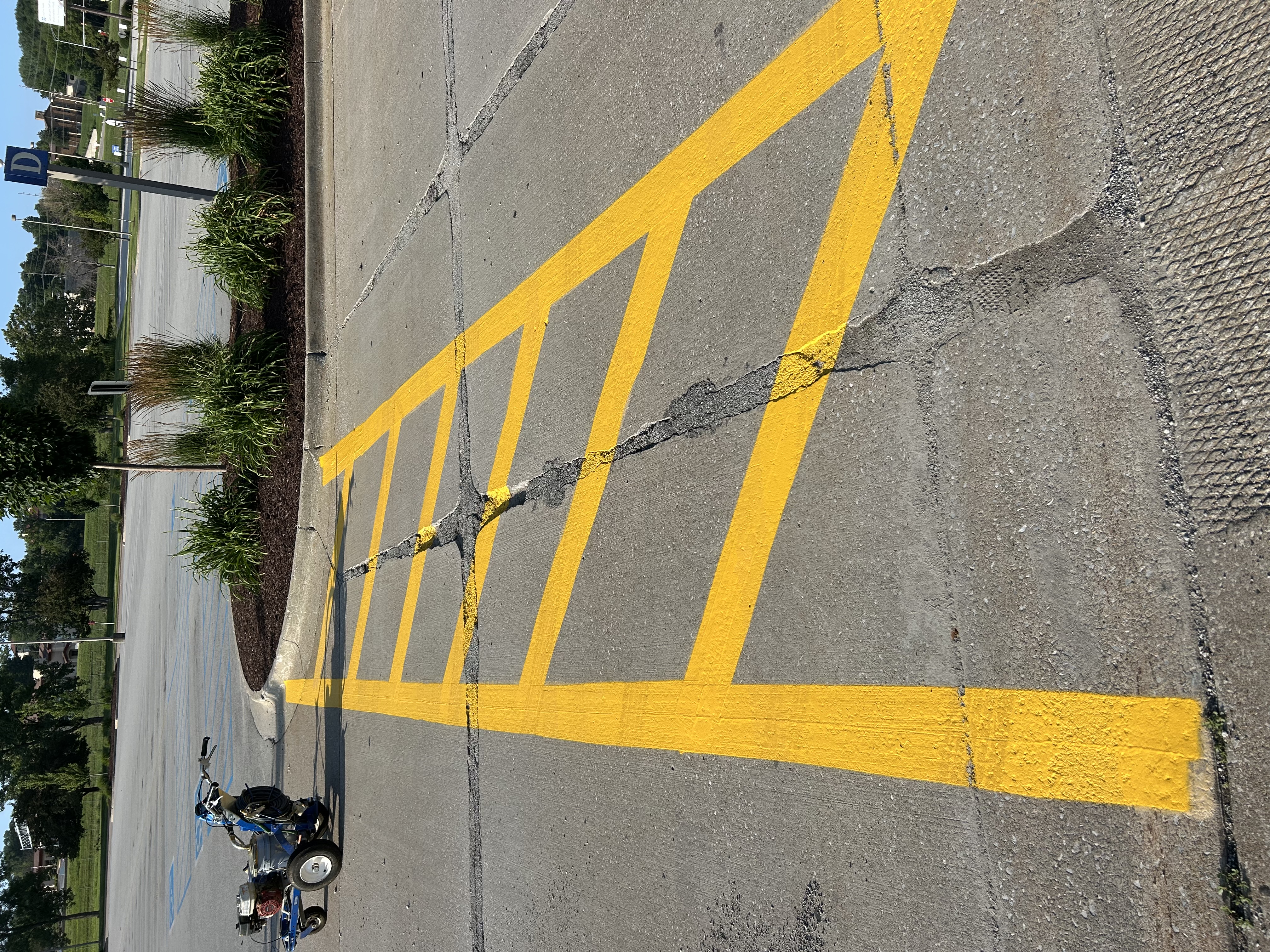 Striping machine applying fresh parking lot lines