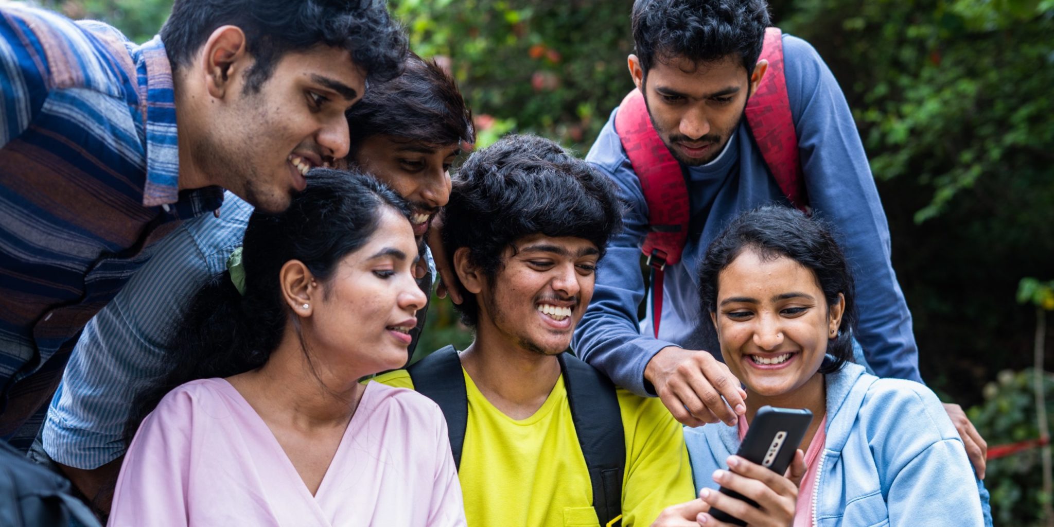Group outdoors with phone