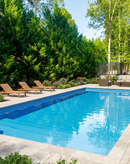 Completed rectangular fiberglass pool in a landscaped backyard