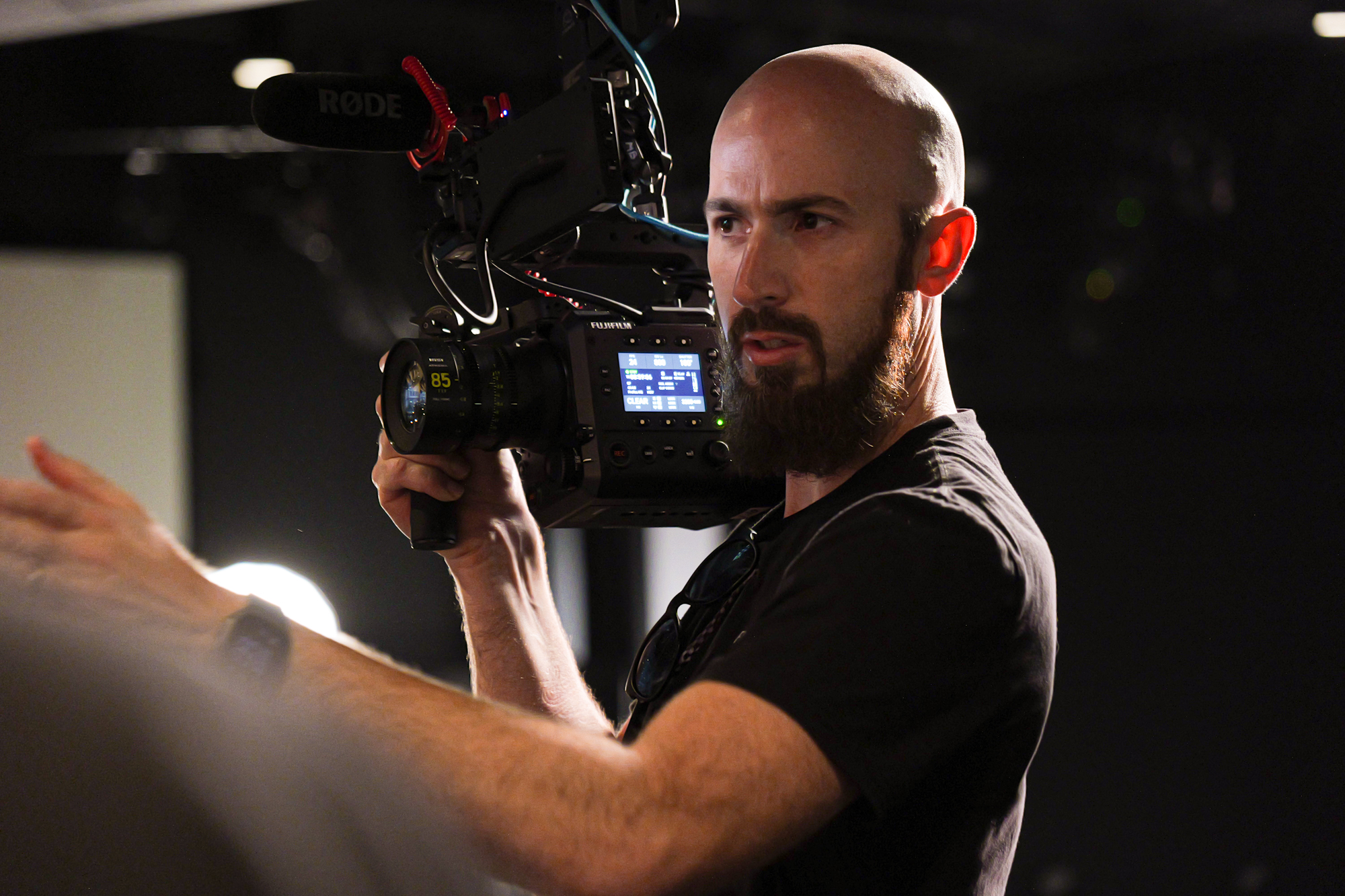 A church creative checking a cinema camera before a production