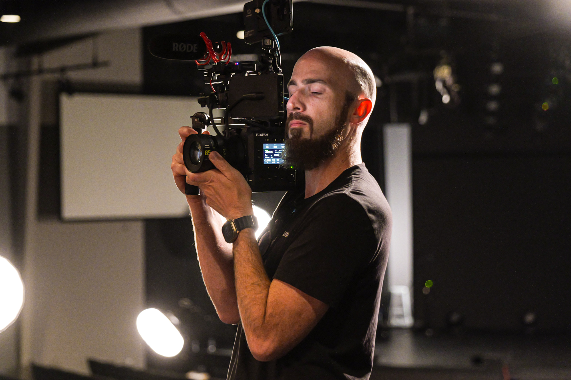 A filmmaker operating a cinema camera during a hands-on lab