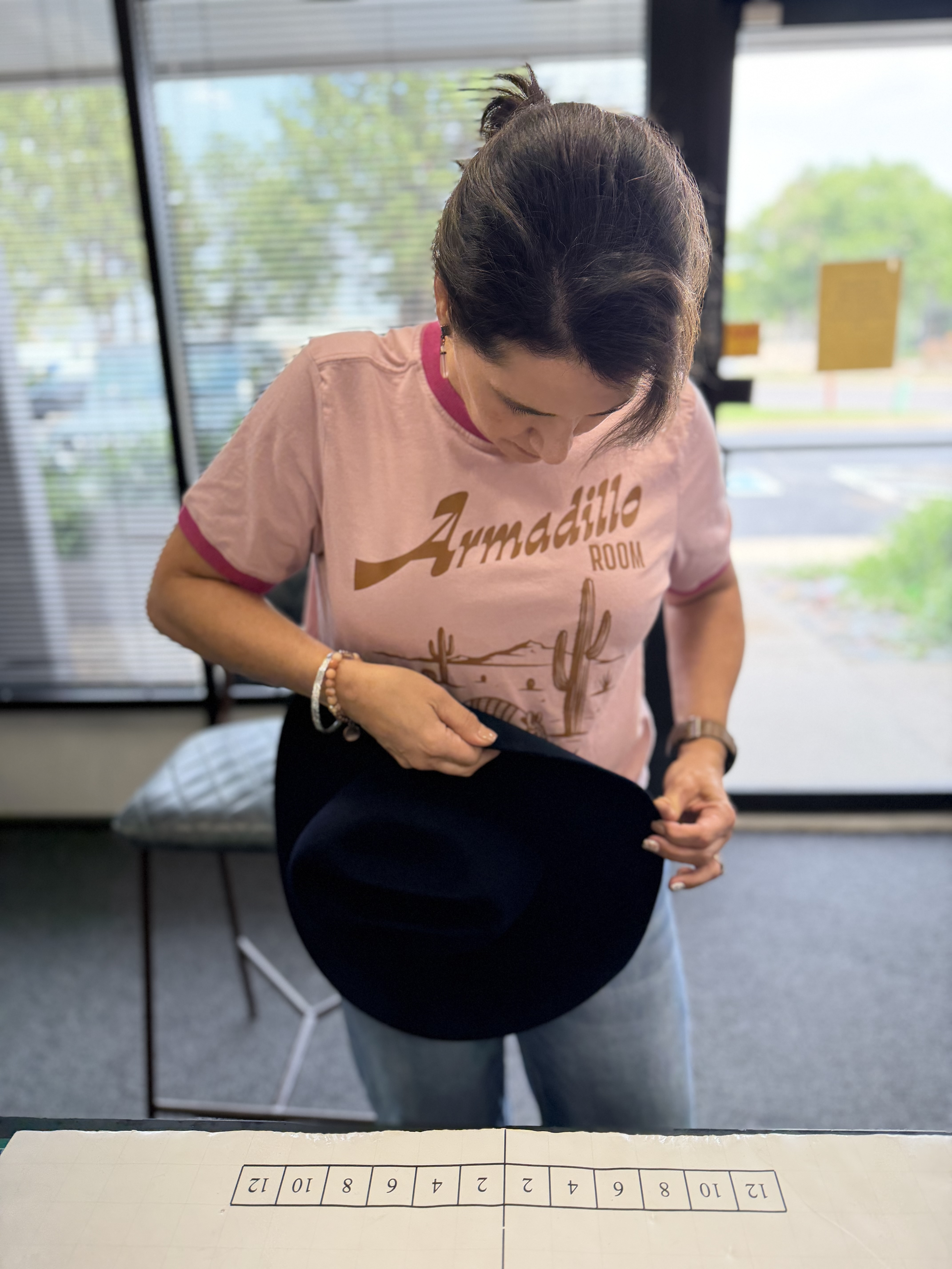 Tina carefully working on a western hat