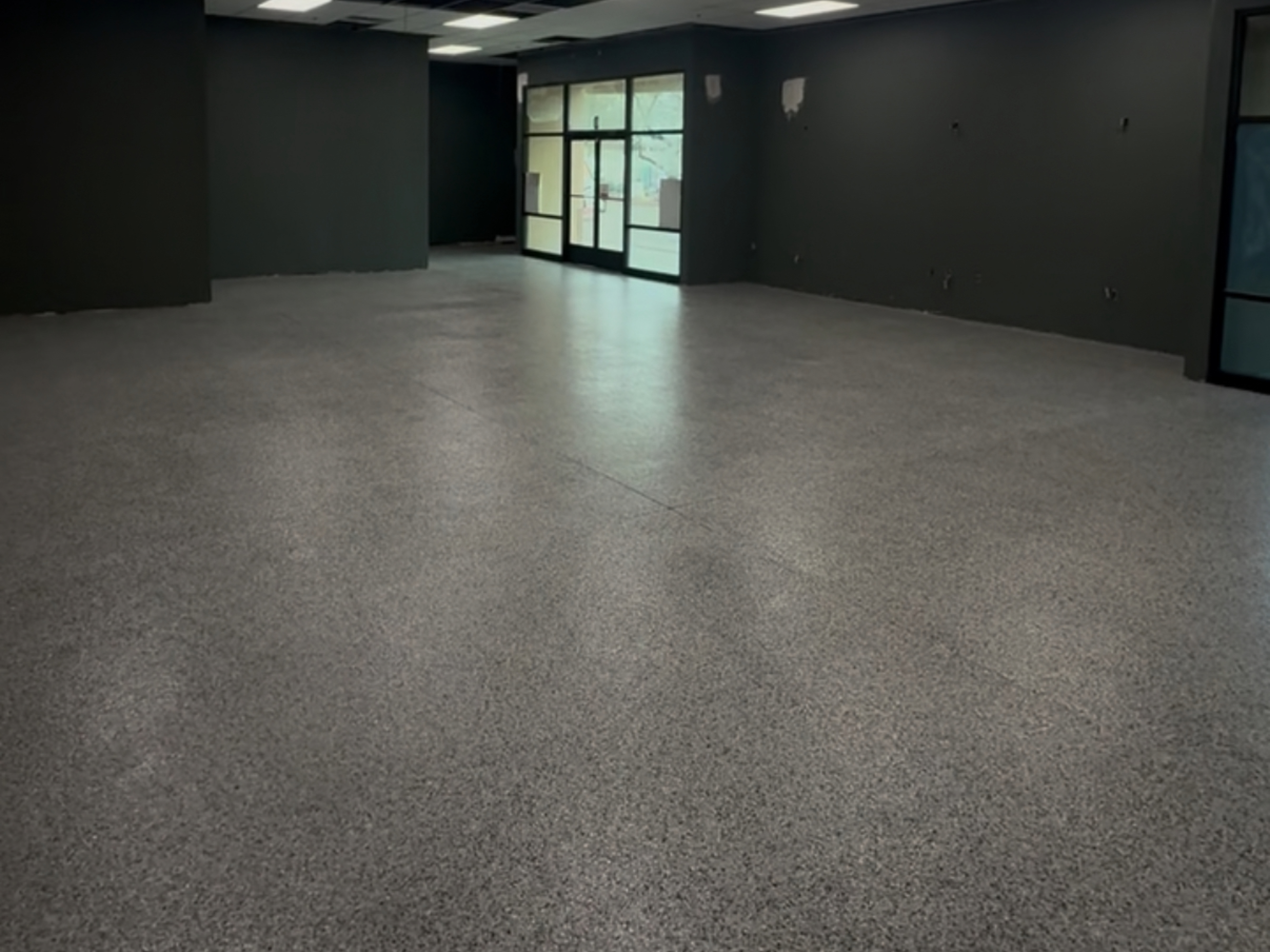 Freshly installed epoxy floor with deep metallic swirls in a clean garage