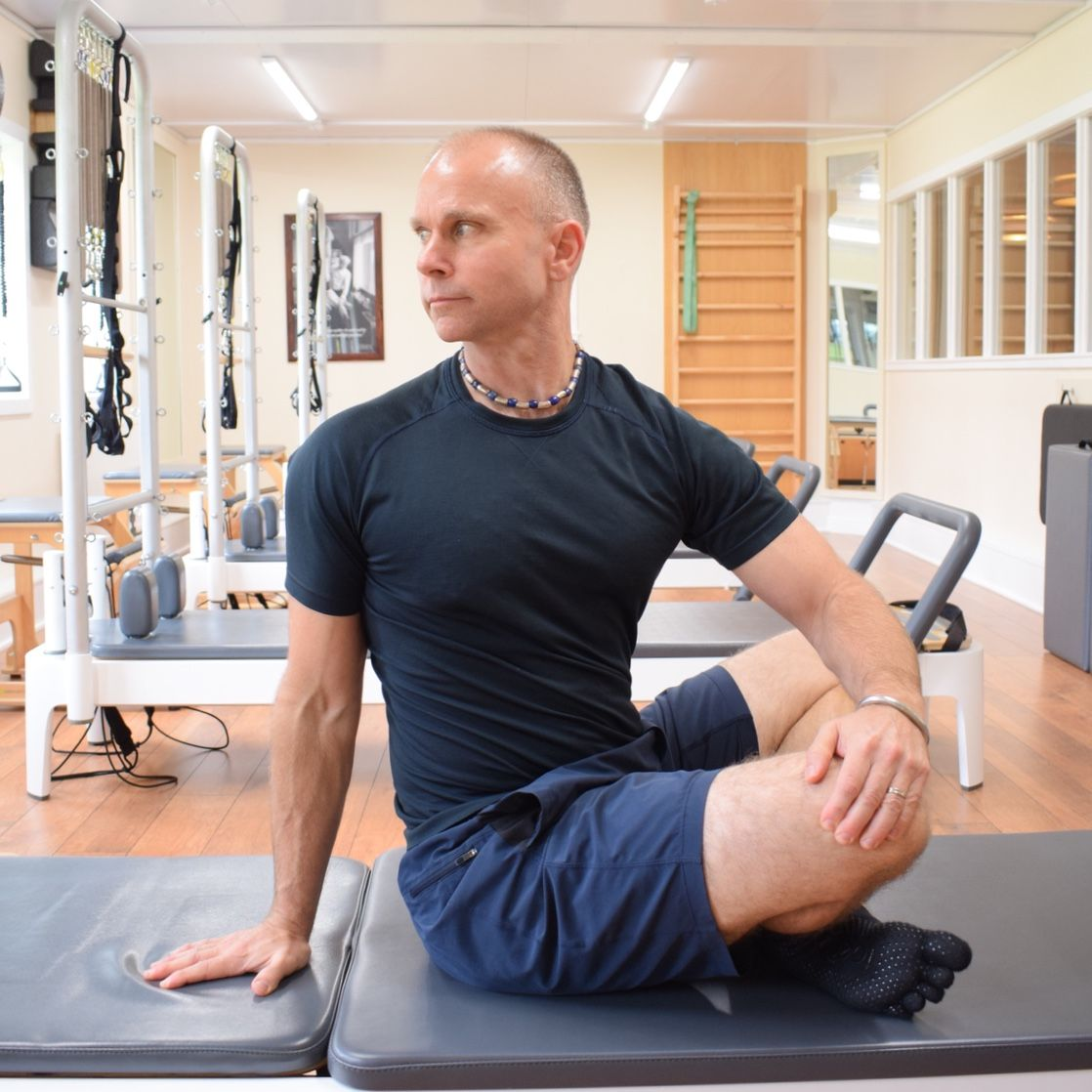 Joakim Valsinger stretching on a Pilates reformer