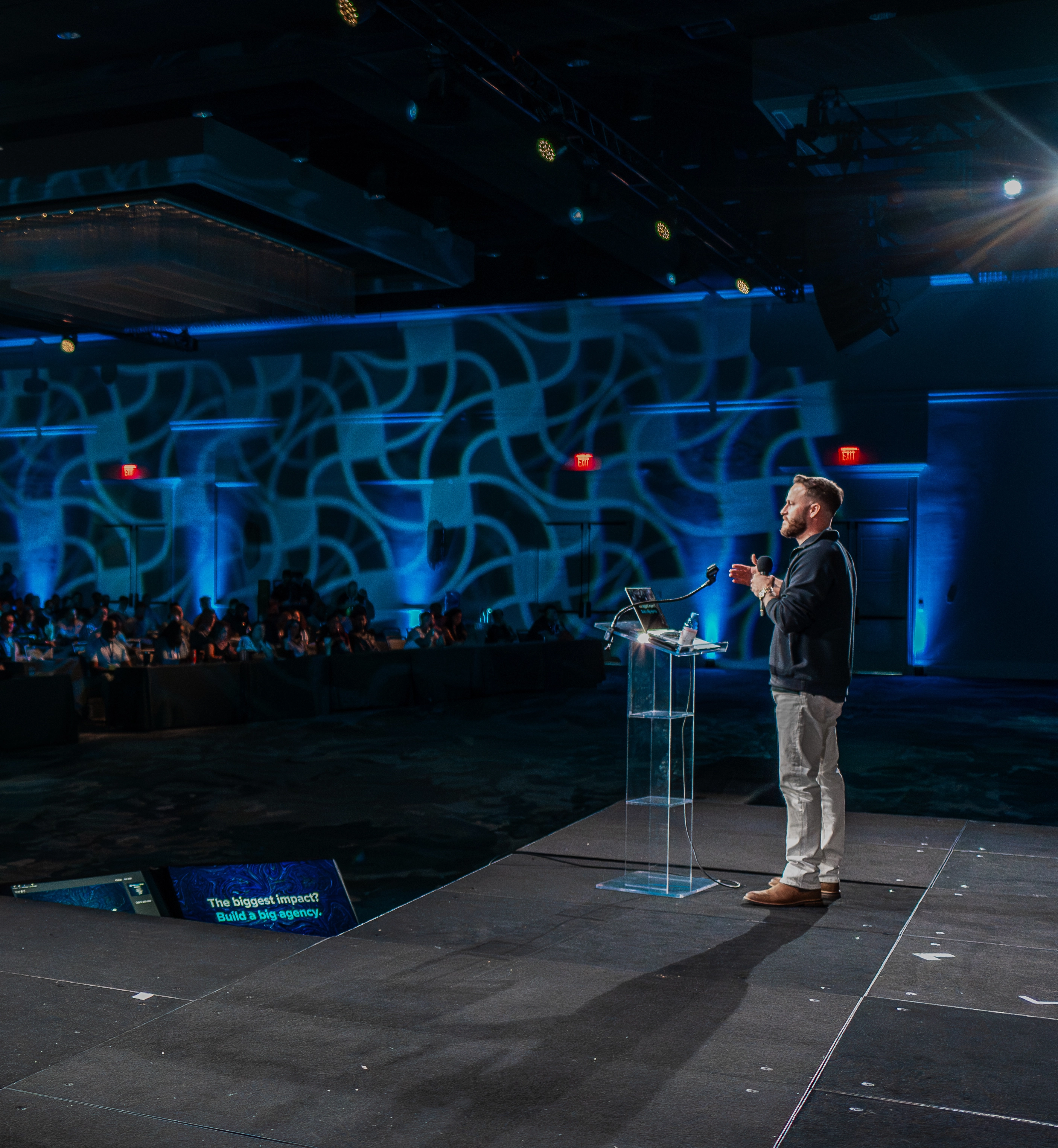 Justin Brock speaking on stage