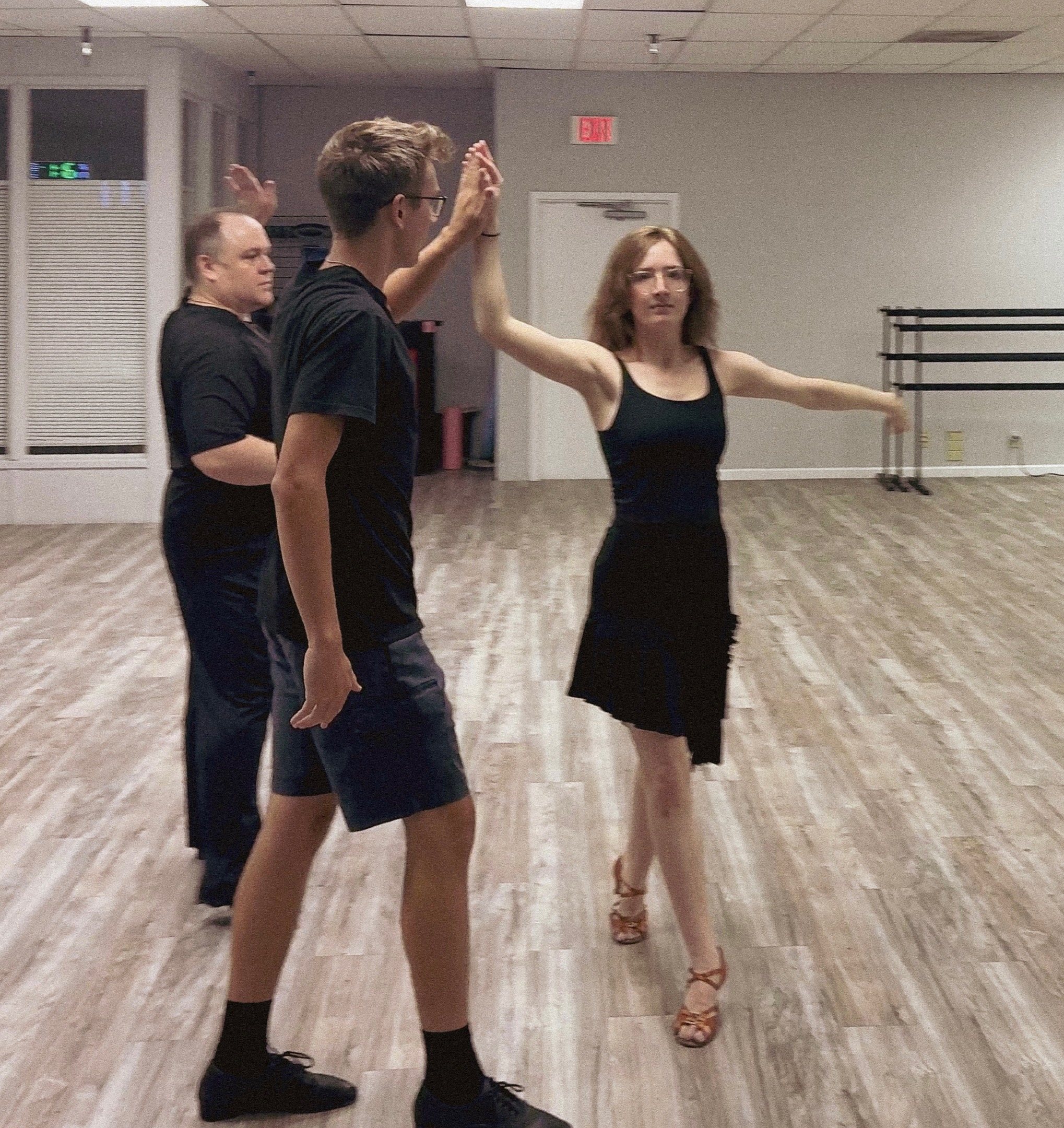Ross Pearce teaching two students during a private ballroom dance lesson at The Phoenix Ballroom Academy.