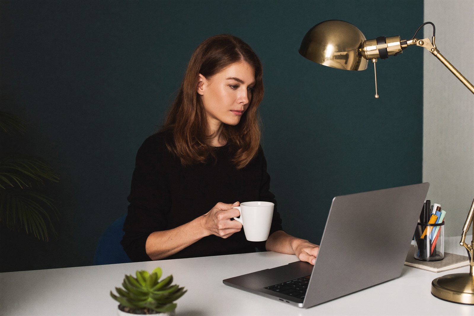 An assistant reading her morning briefing with a coffee in hand