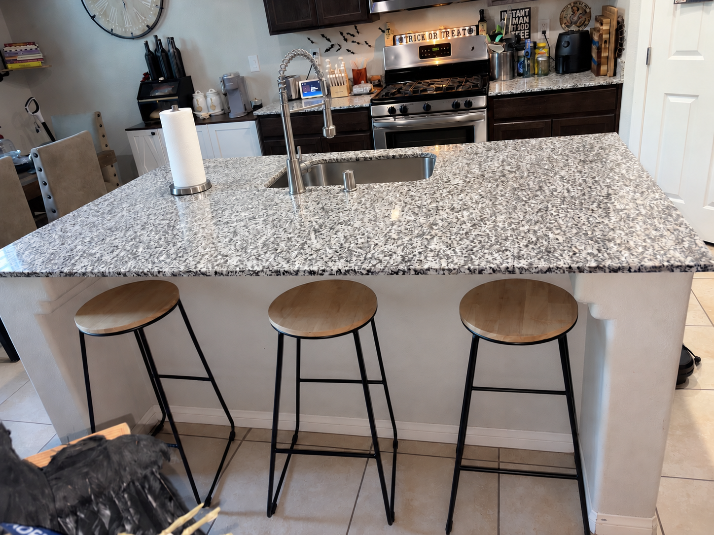 Polished white marble kitchen island with a brushed gold faucet