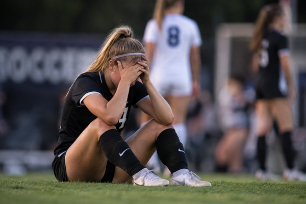 Youth soccer player struggling with confidence and pressure during competition