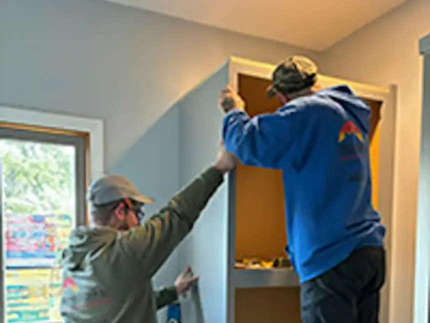 Installing cabinets in a white shaker kitchen