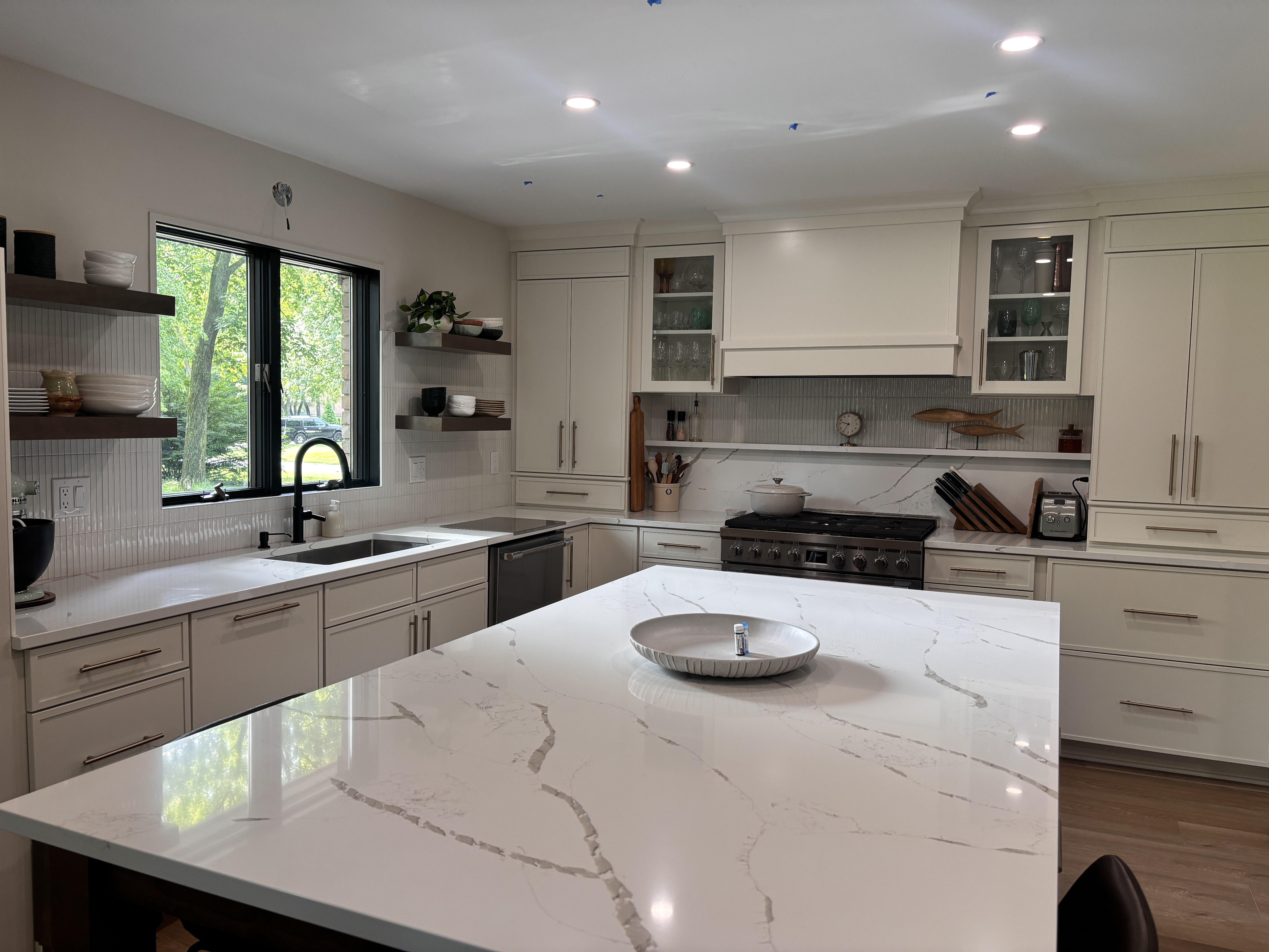 A finished HomeWorks kitchen with quartz island and custom cabinetry
