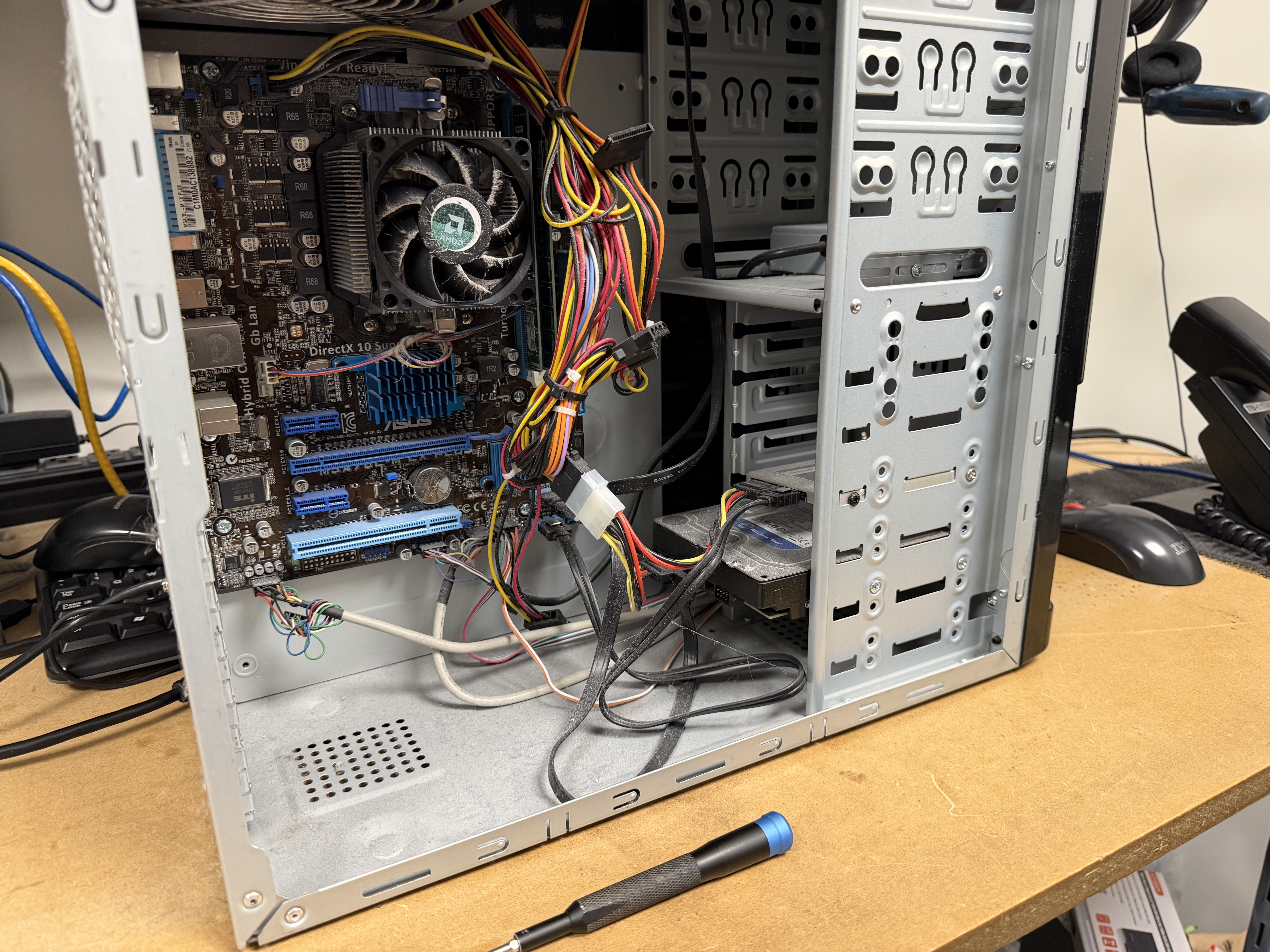 Technician at Priority 1 Computer Service Victoria BC installing 1TB SSD and 16GB RAM into refurbished Lenovo during computer upgrade and data transfer