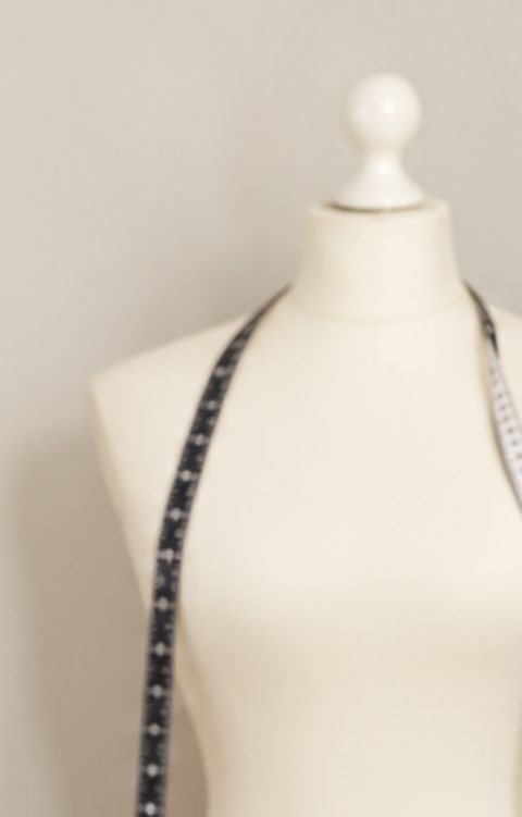 A dress form with a tape measure