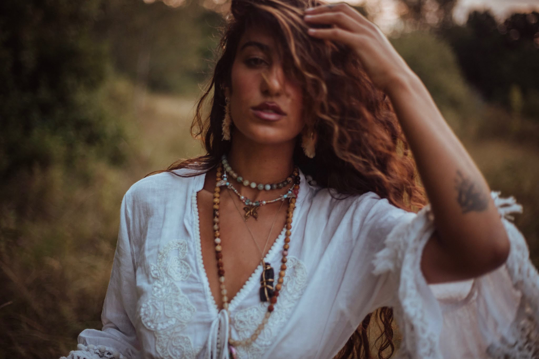 Savannah in a meadow at dusk, hand in her hair