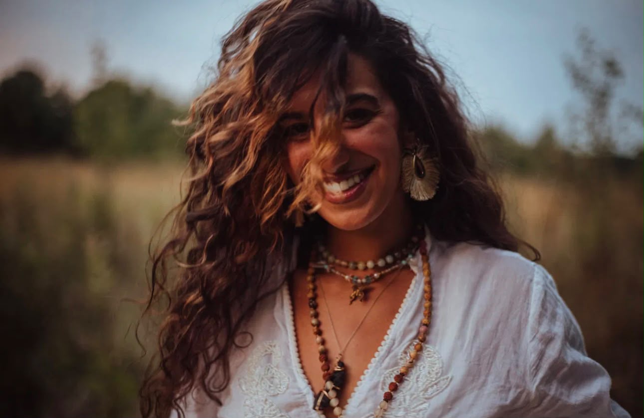 Laughing in a golden field at dusk