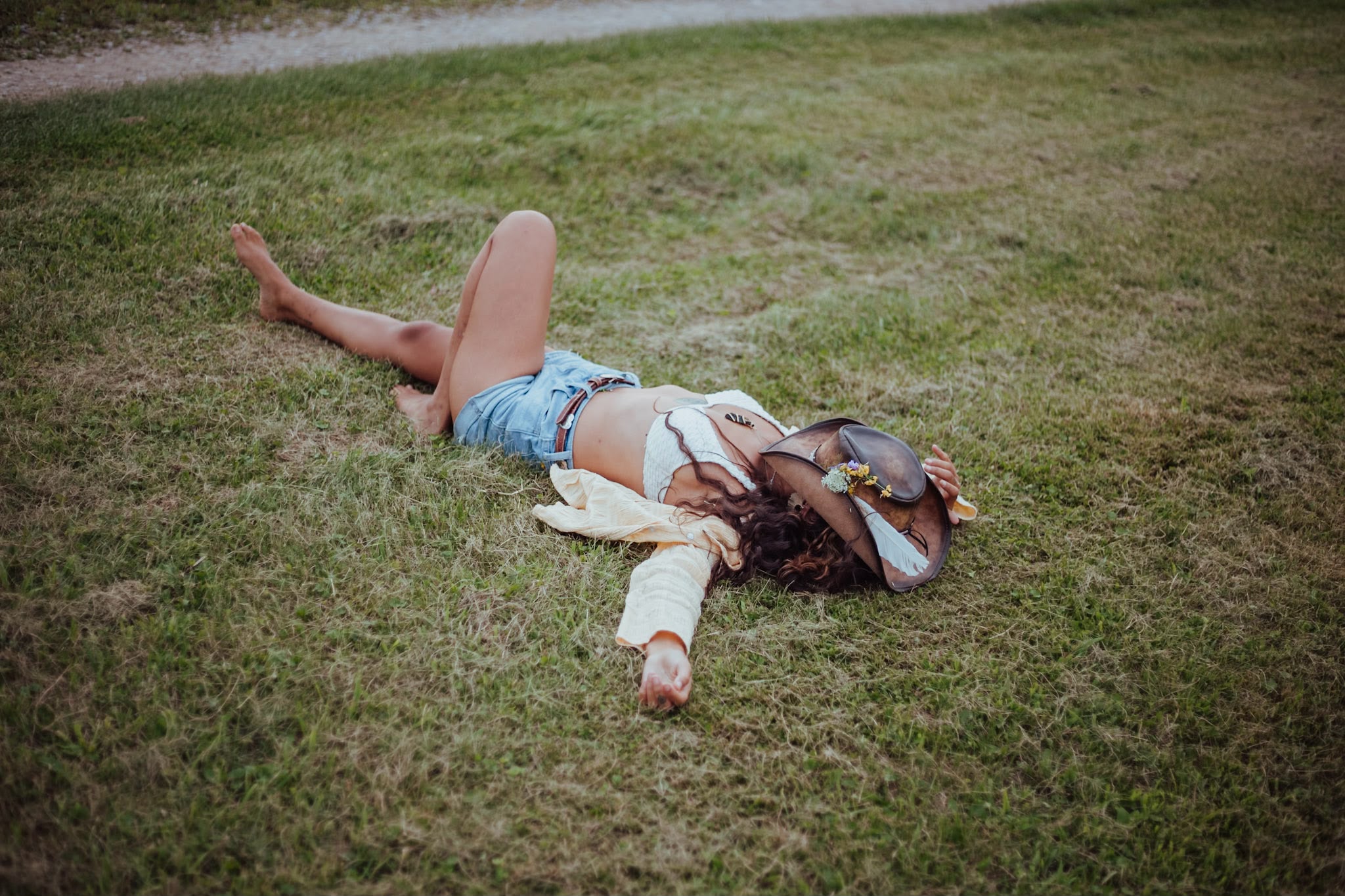Resting in the grass, hat over face