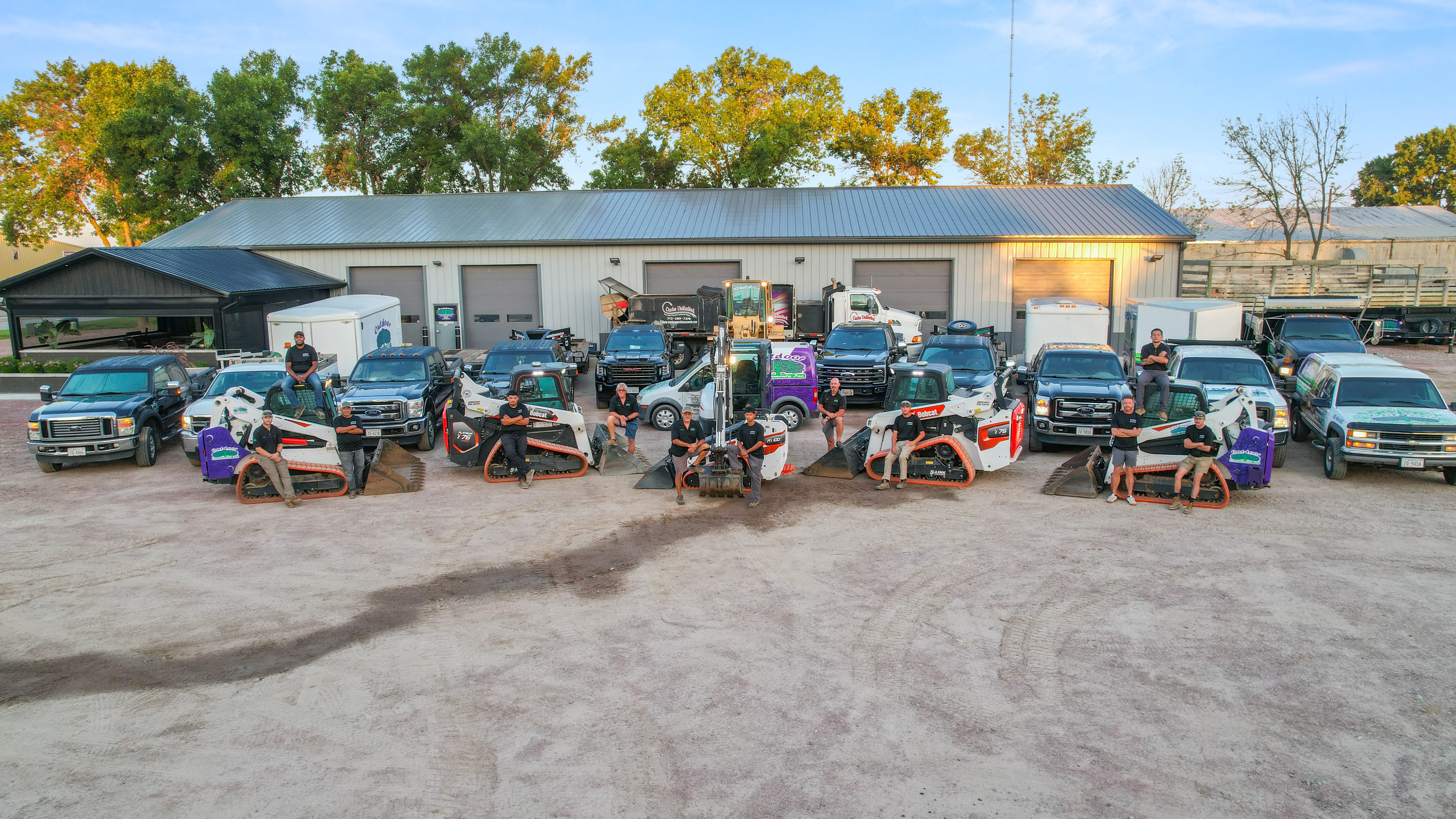 OEI crew and fleet staged in front of the shop