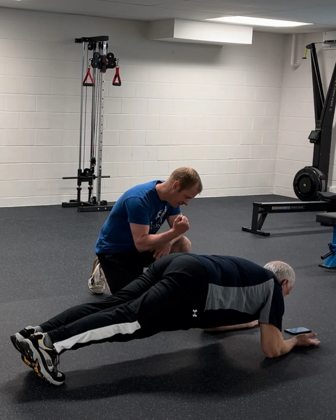 A Functional Life coach guiding a client through a plank