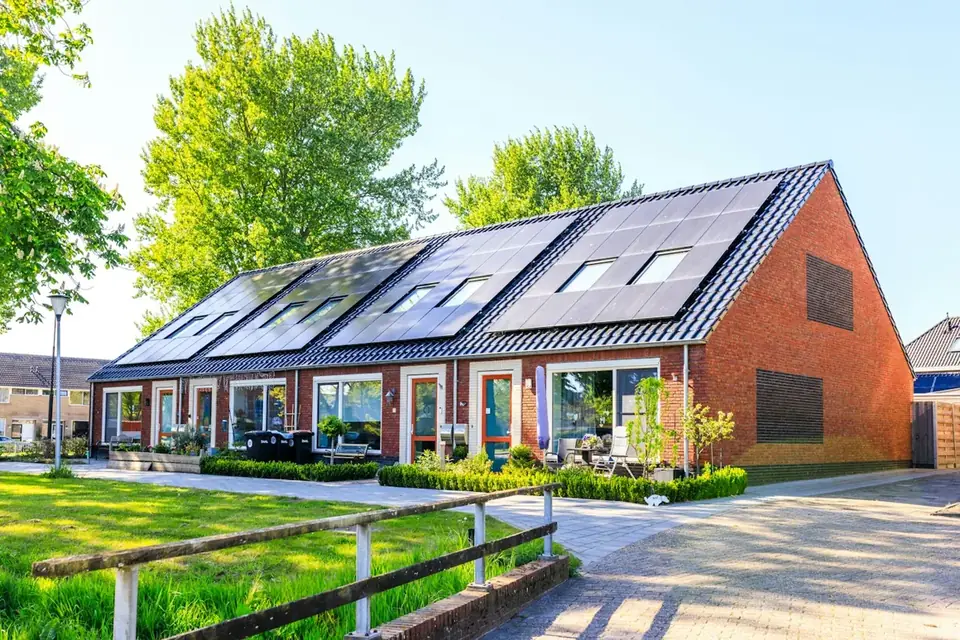 Homes with solar panels on their roofs among greenery