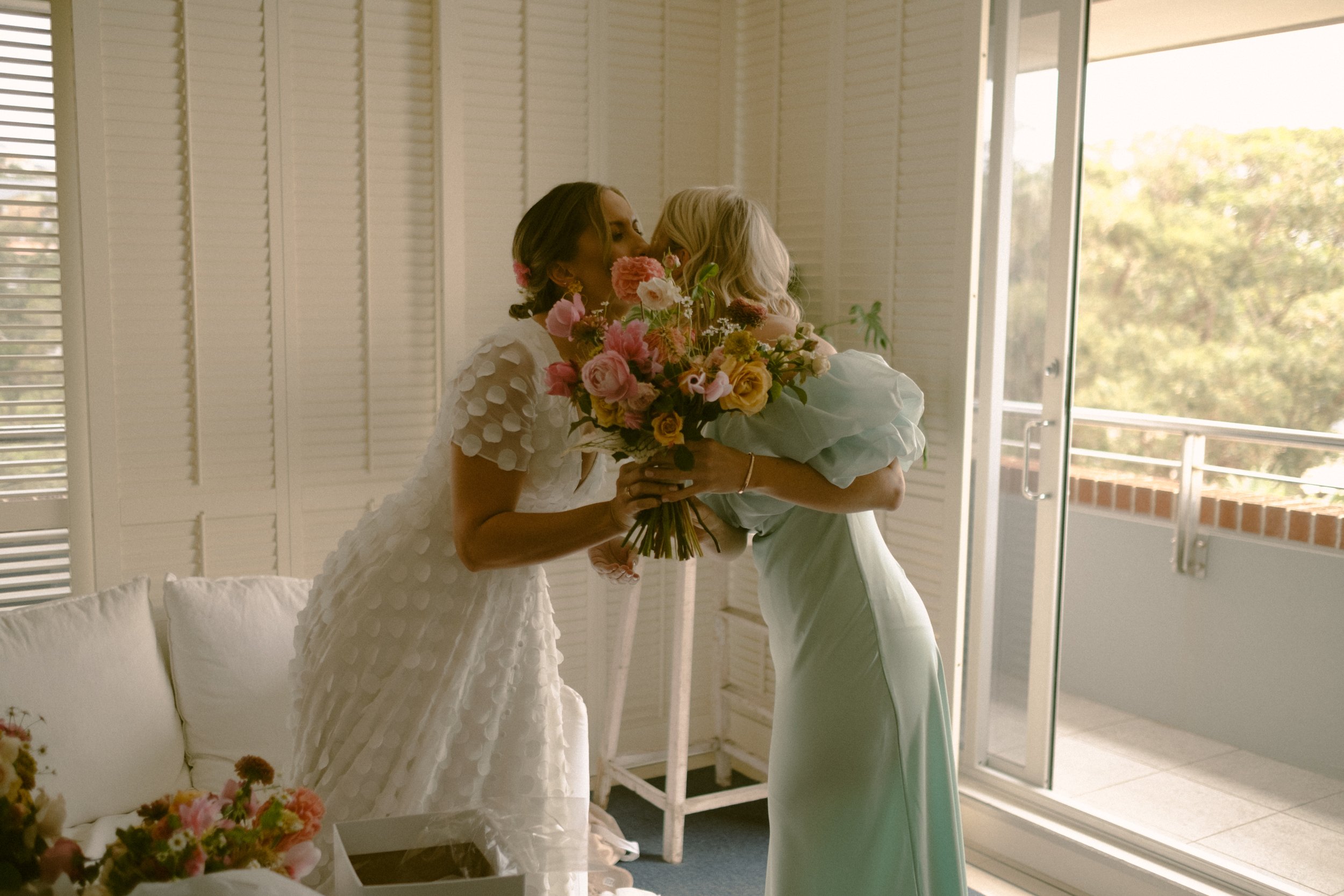 Outdoor ceremony beneath a floral arch