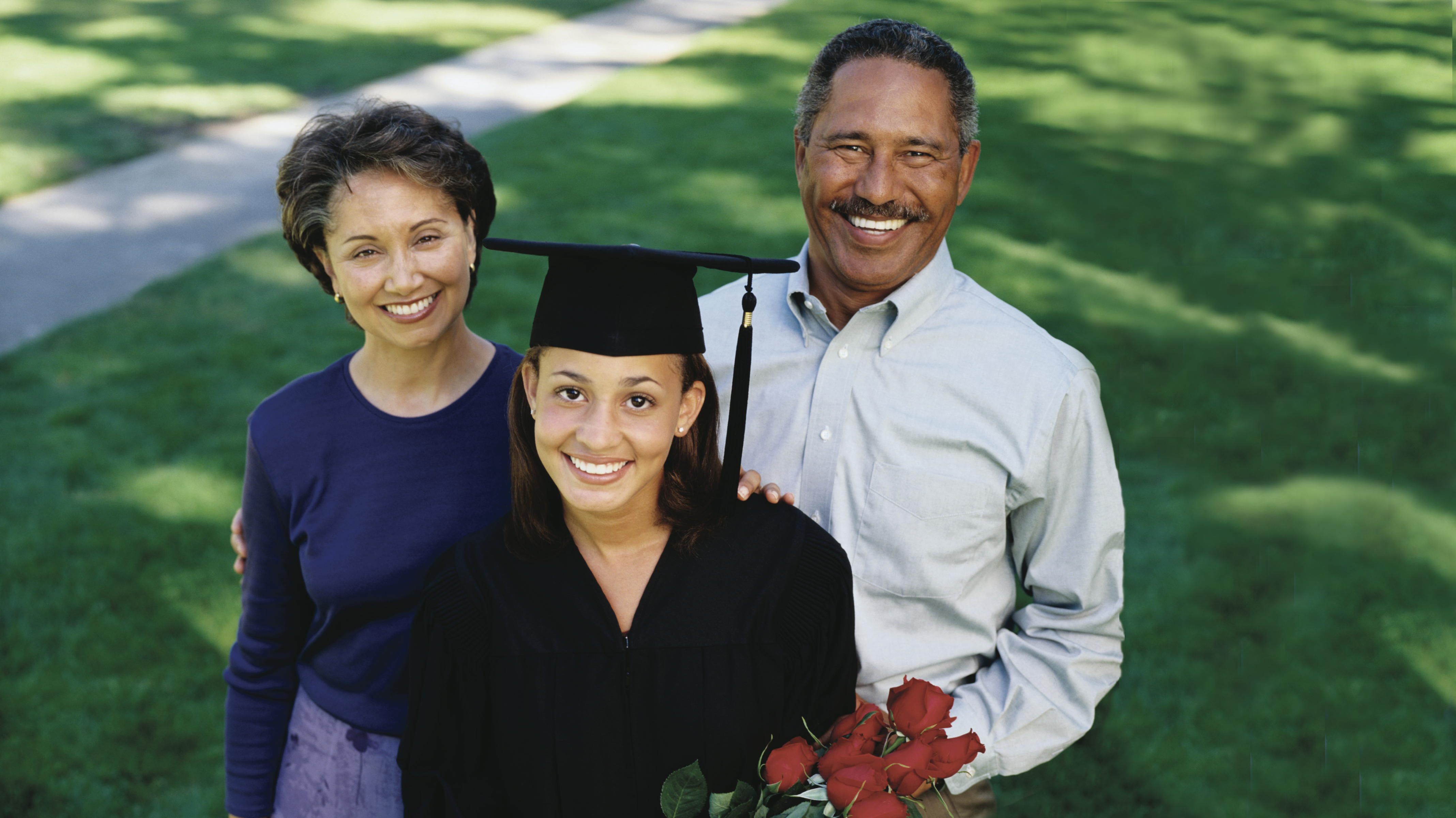 Happy Smiling Mother, Father, and Graduating Daughter