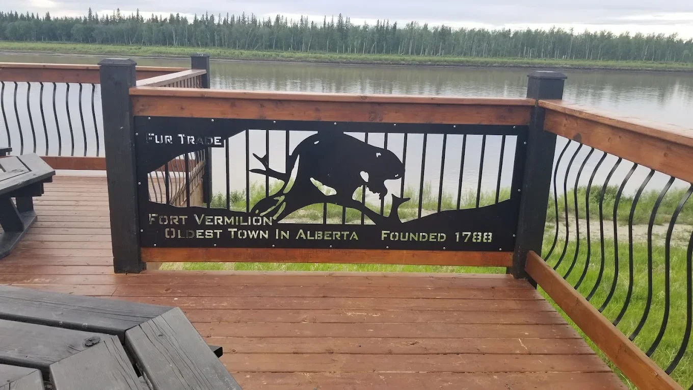 Metal sign reading 'Fort Vermilion Oldest Town in Alberta Founded 1788' with beaver artwork
