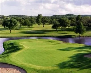 Scenic view of Frio Valley Ranch Golf Course showing manicured greens and the clubhouse against the Concan, TX, hill country backdrop.