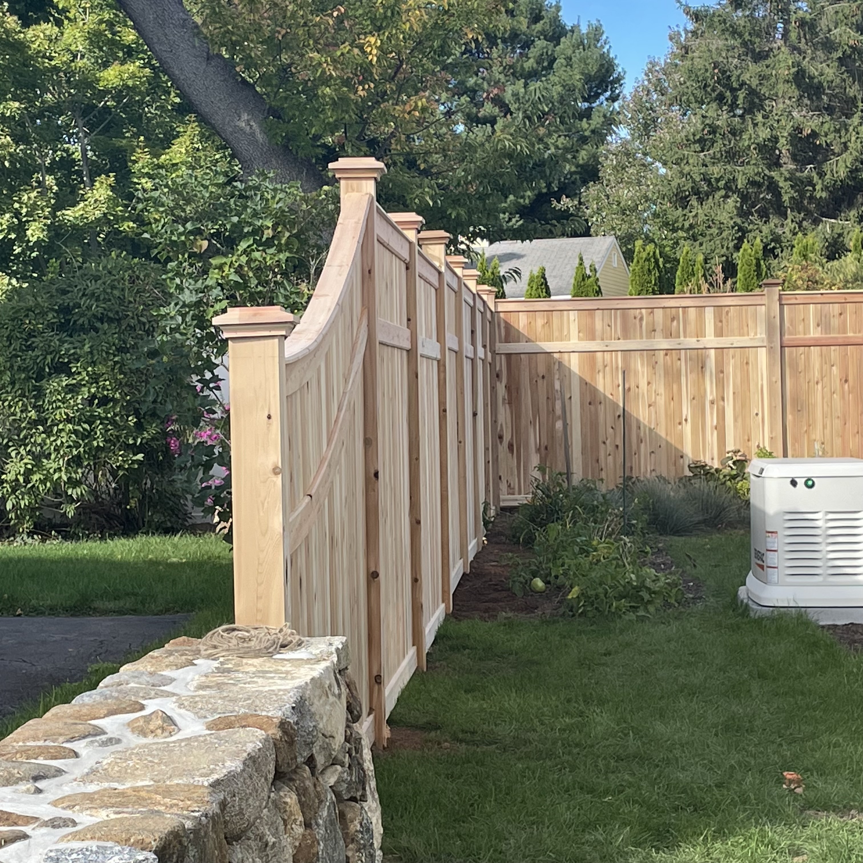 Wooden fence with a gate and grass behind it