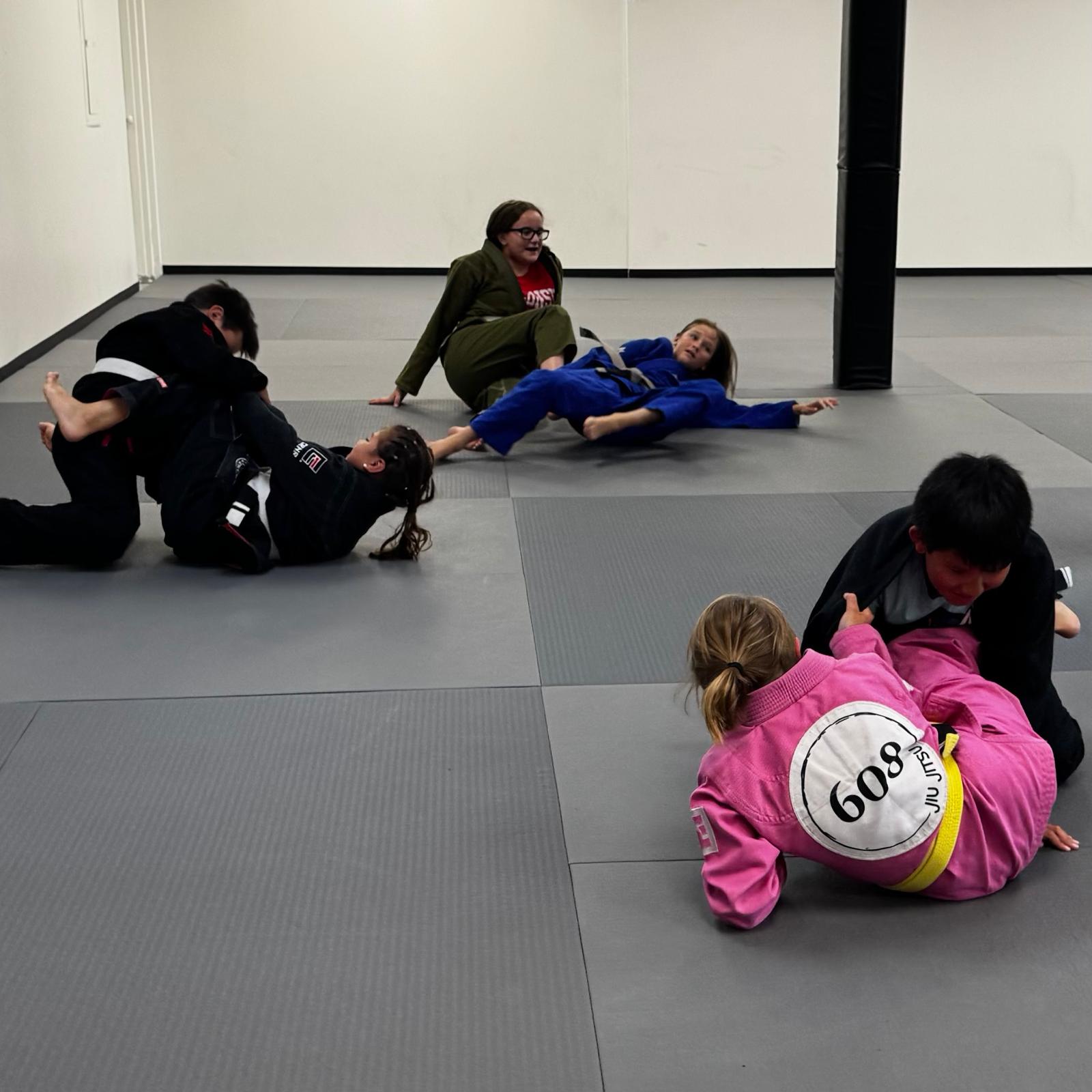 Two children practice jiu jitsu drilling together at 608 Jiu Jitsu