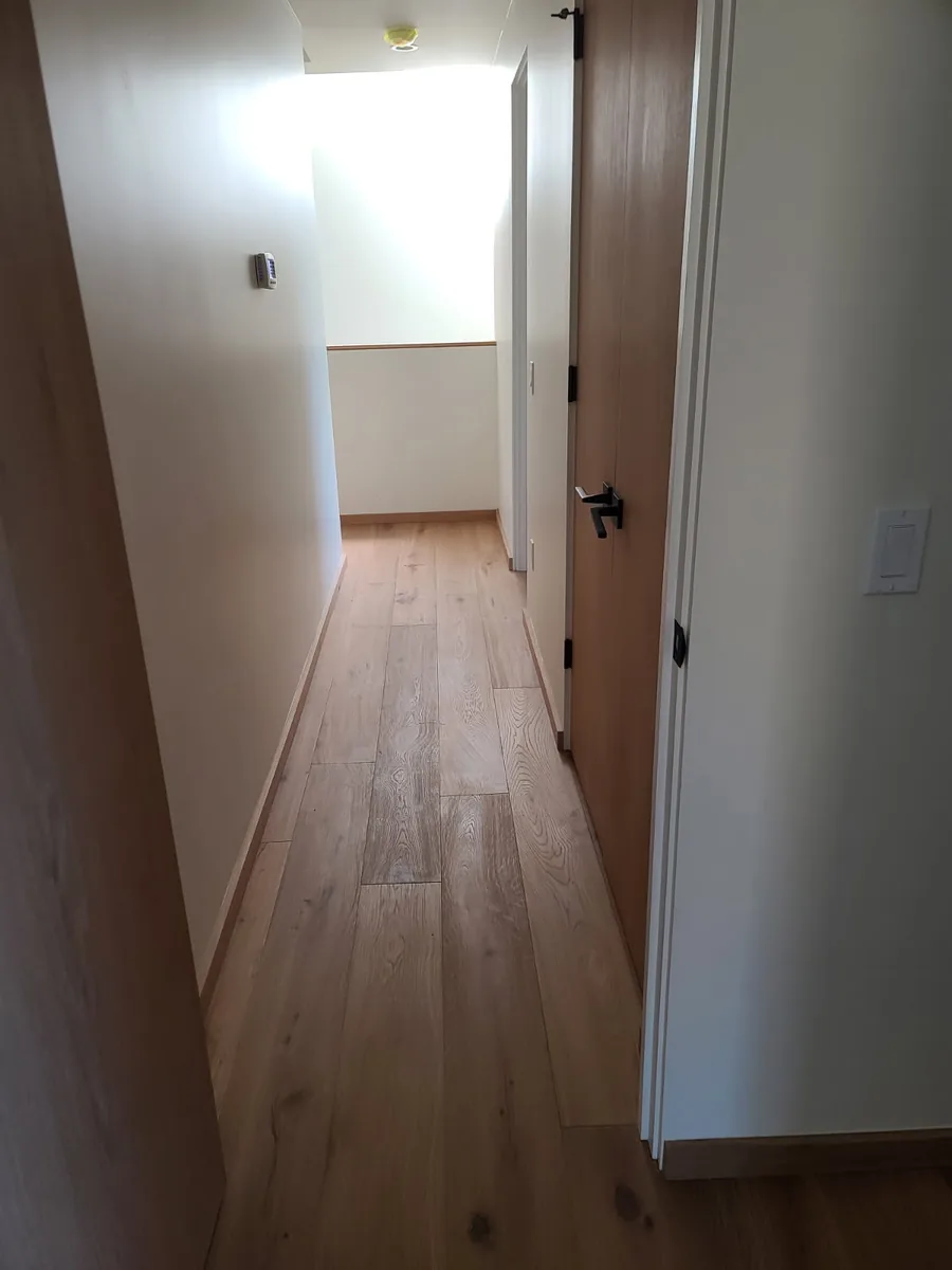 Hugo's Services — Hallway with wood flooring and doors
