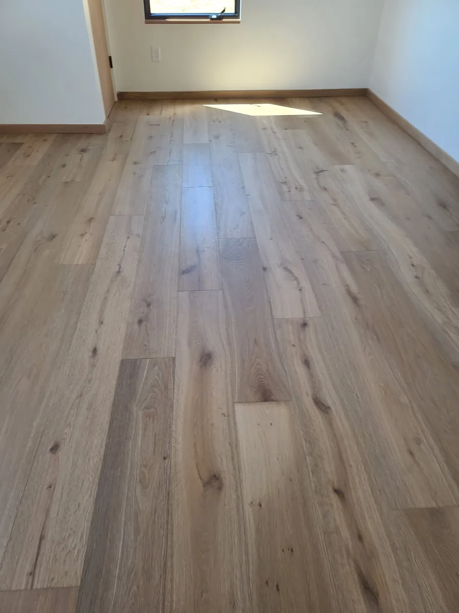 Hugo's Services — Room with hardwood flooring and a window