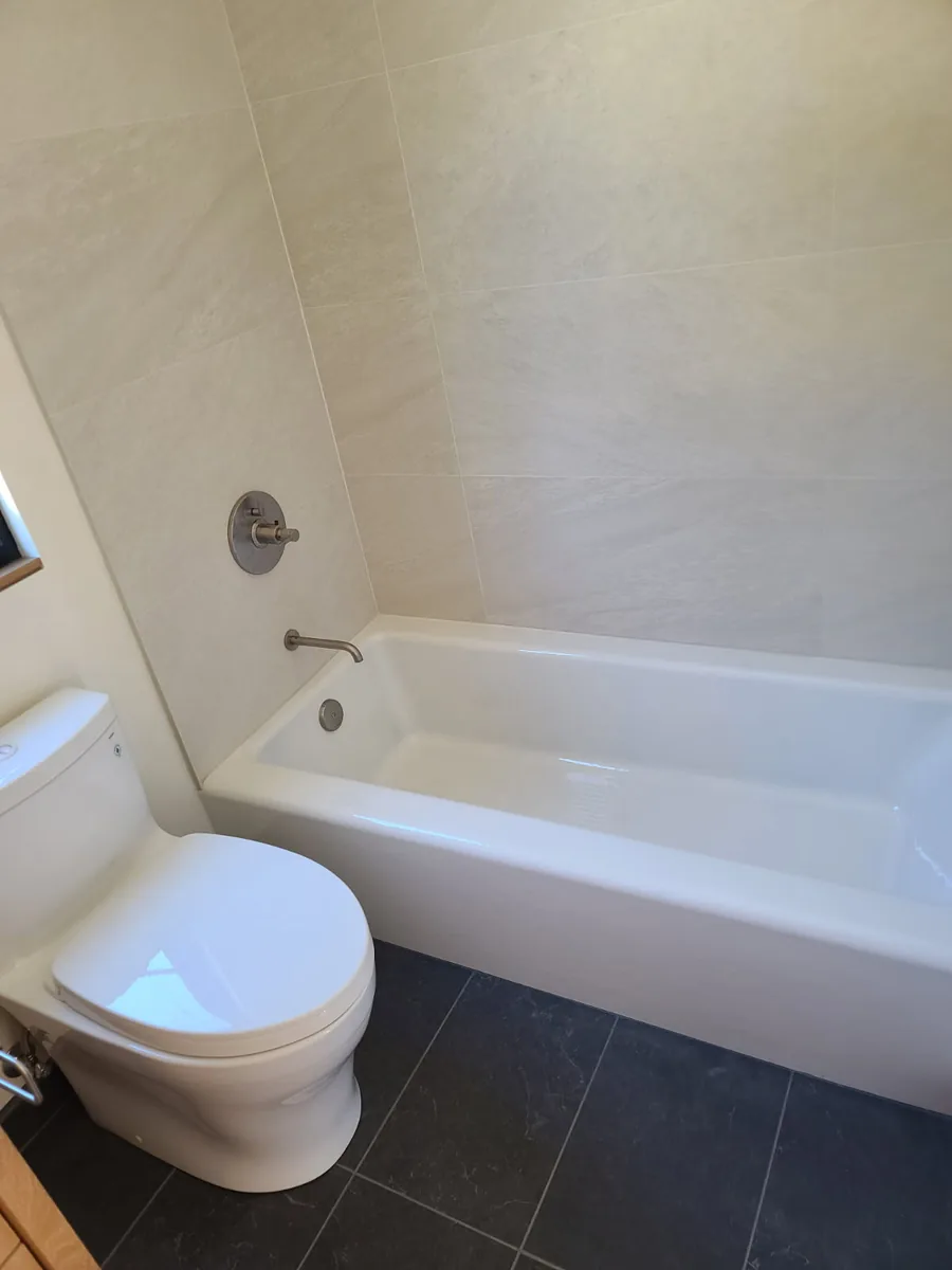 Hugo's Services — Bathroom with bathtub and tile
