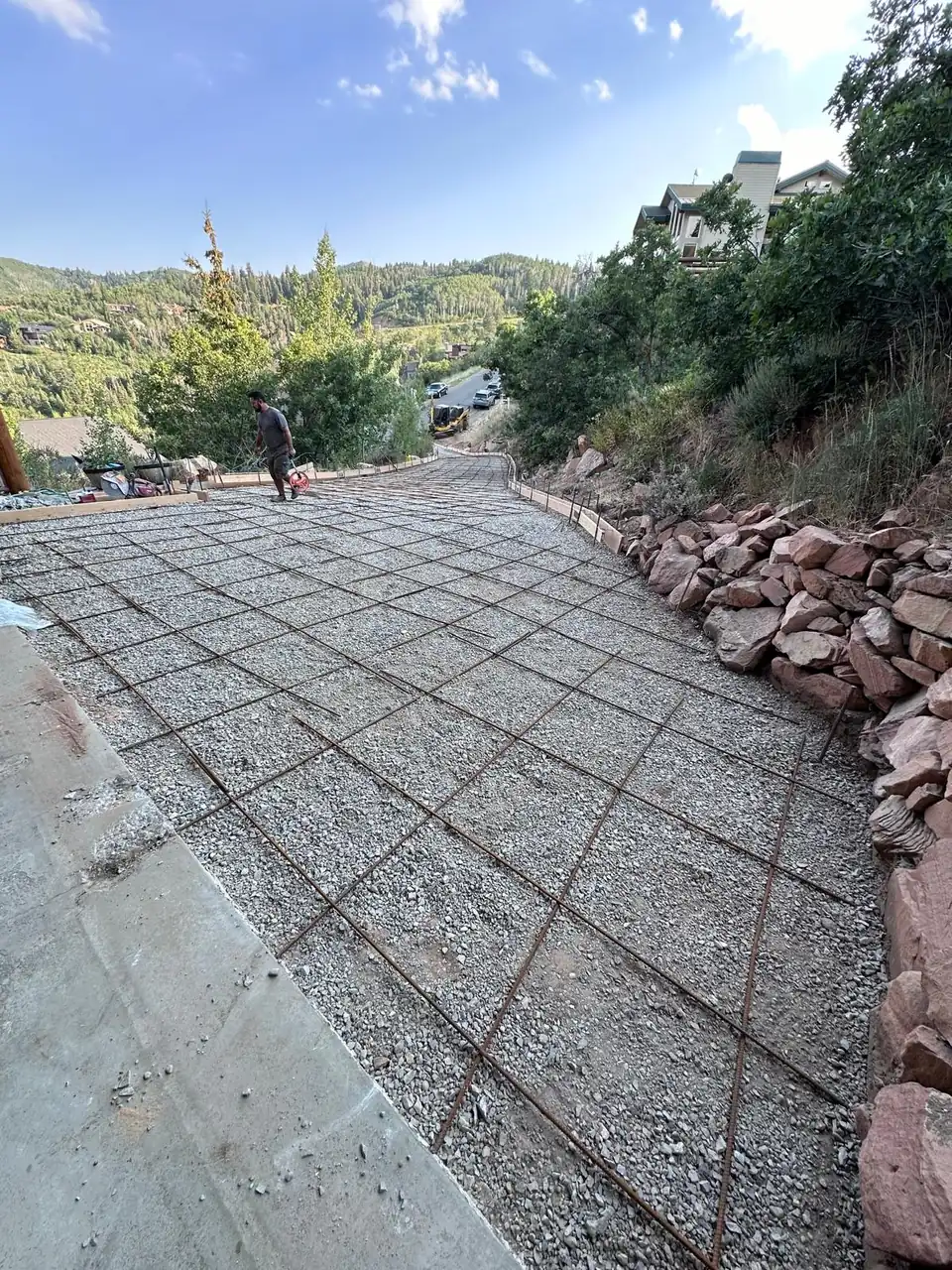 Compacted driveway base and steel reinforcement prepared before a concrete pour