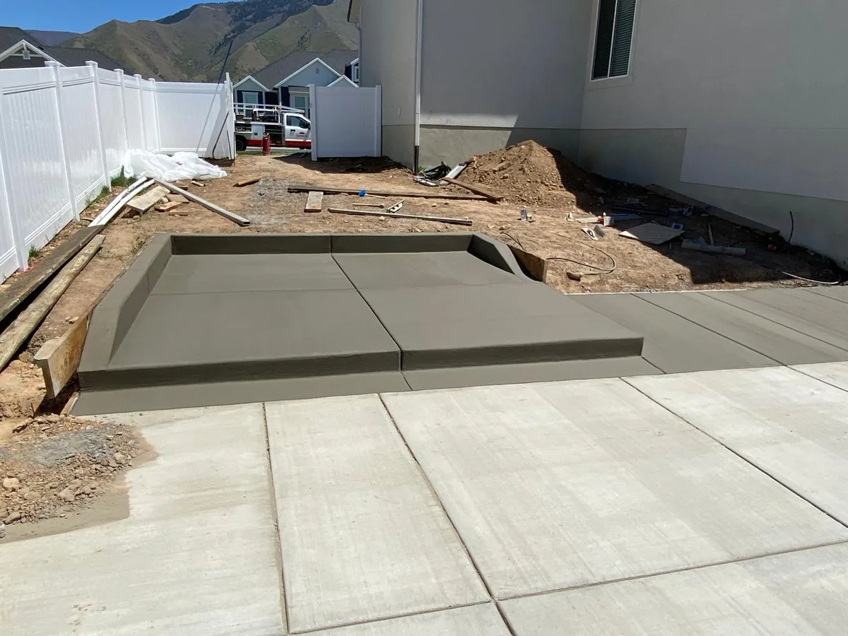 Fresh concrete pad and steps completed beside a Salt Lake County home