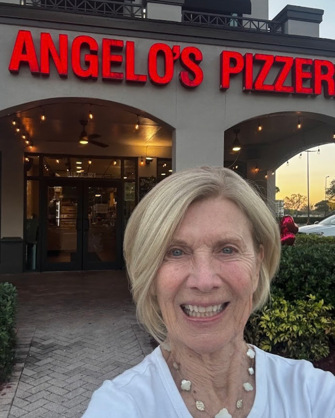 Woman smiling outside Angelo’s Pizza on University Drive in Davie, Florida near Nova Southeastern University during community fundraiser event. Woman smiling outside Angelo’s Pizza on University Drive in Davie, Florida near Nova Southeastern University during community fundraiser event.