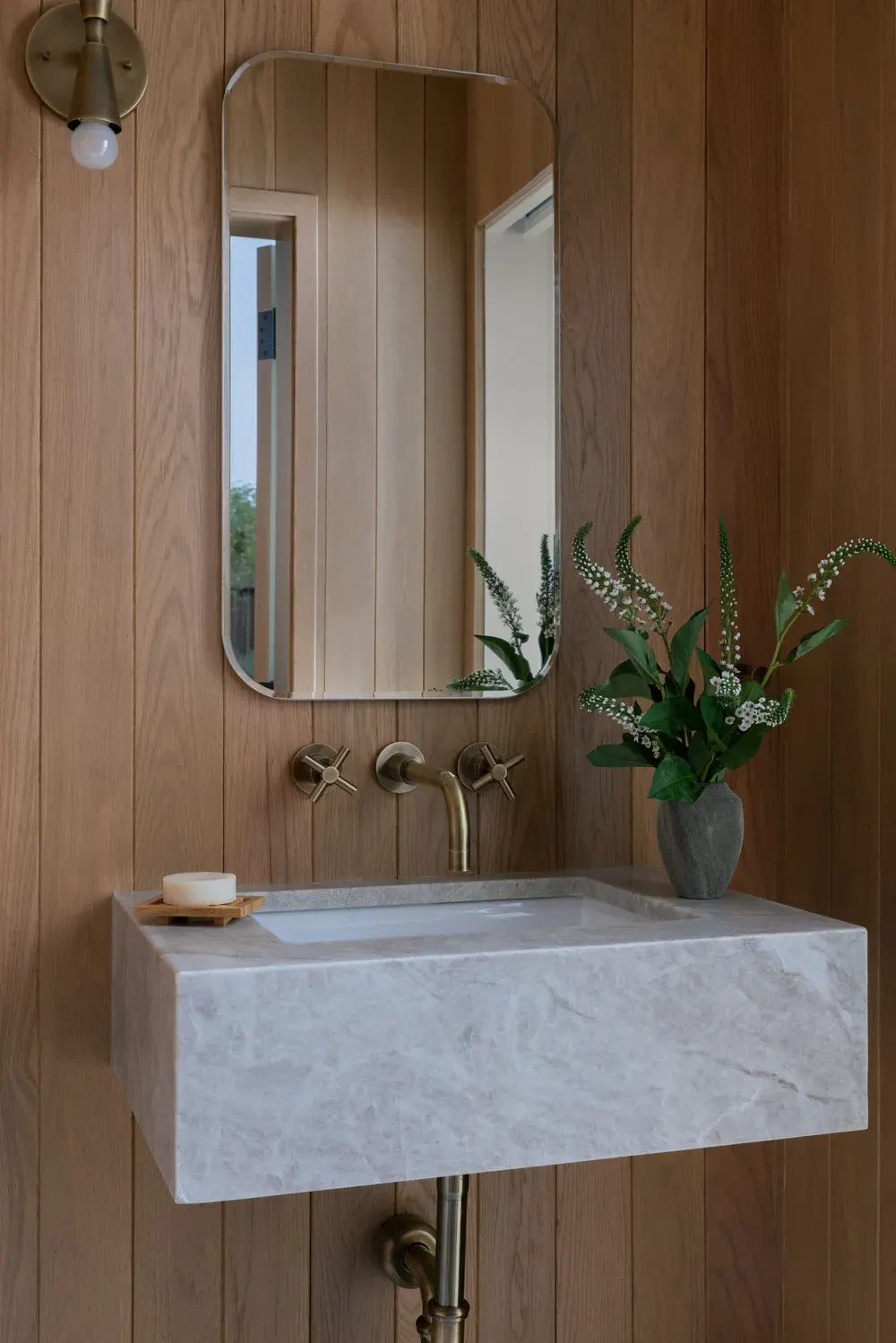Custom stone sink and oak wall paneling
