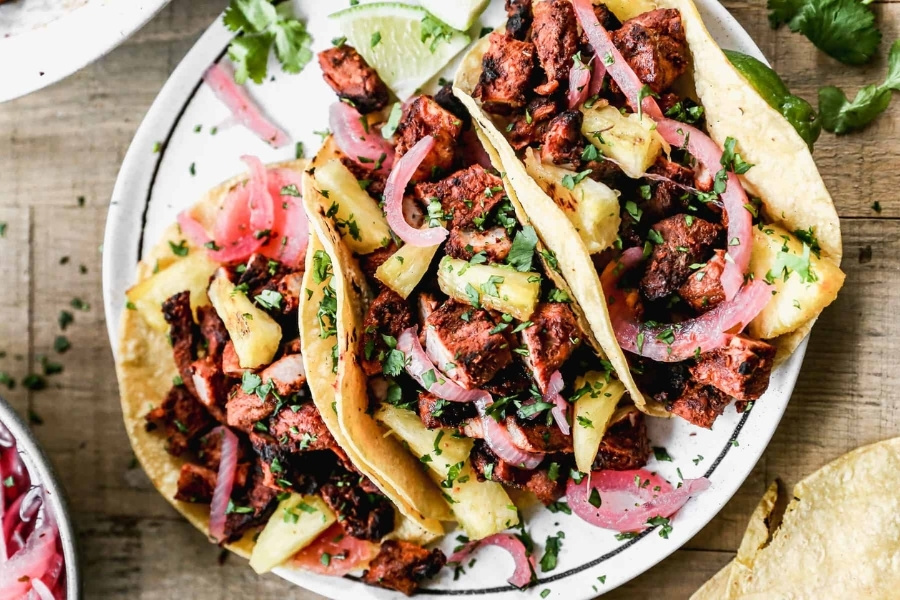 Al pastor tacos with pineapple and onions