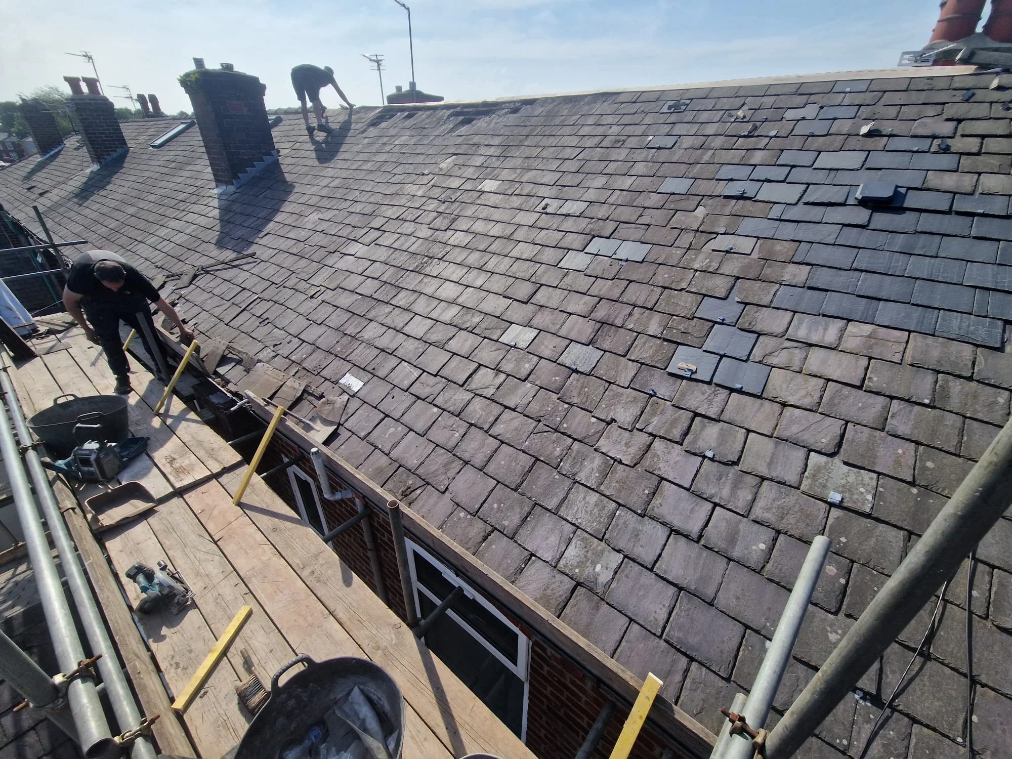 Completed slate re-roof with neat ridge detailing