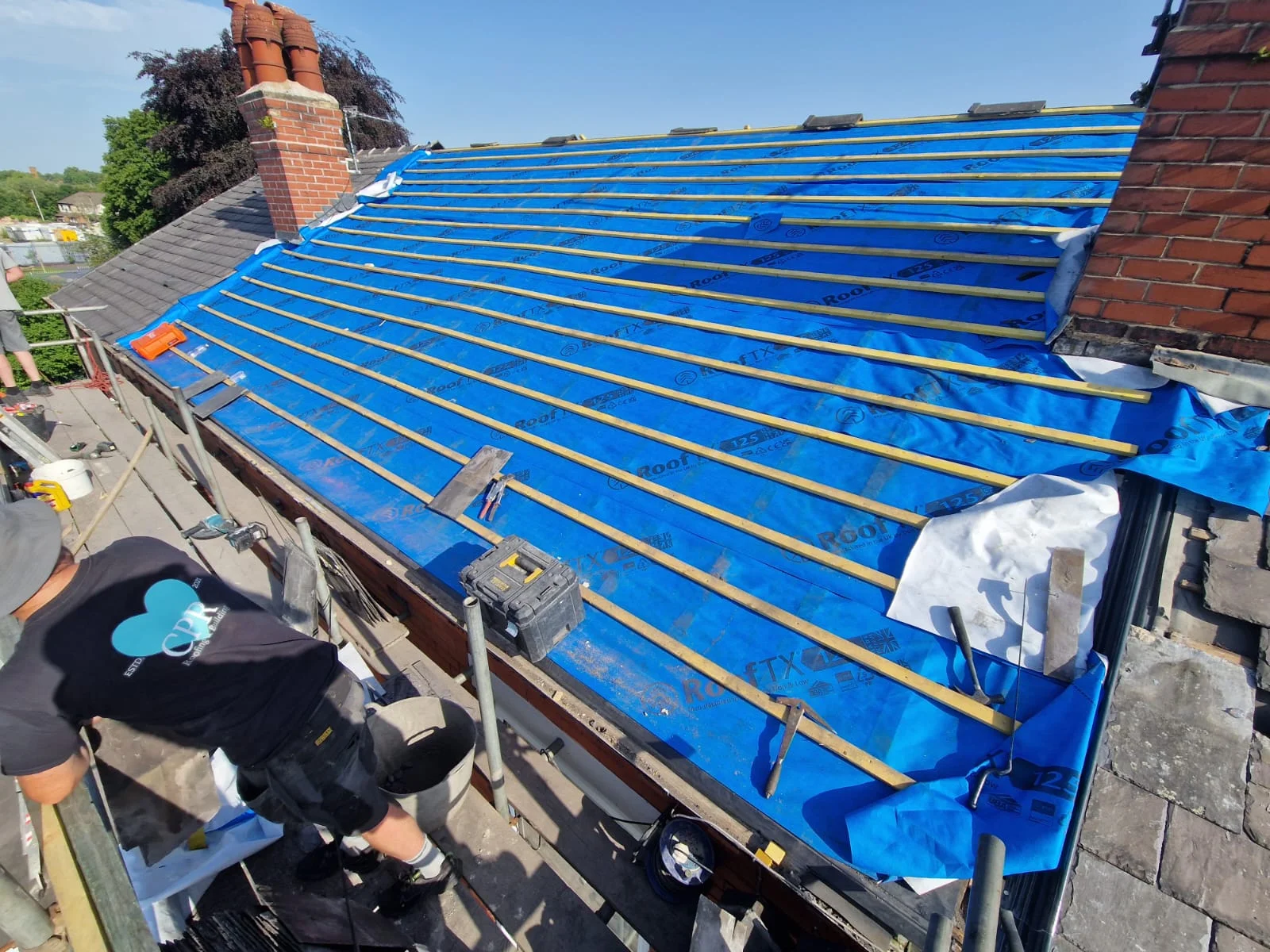 Roof tiling in progress on a residential property