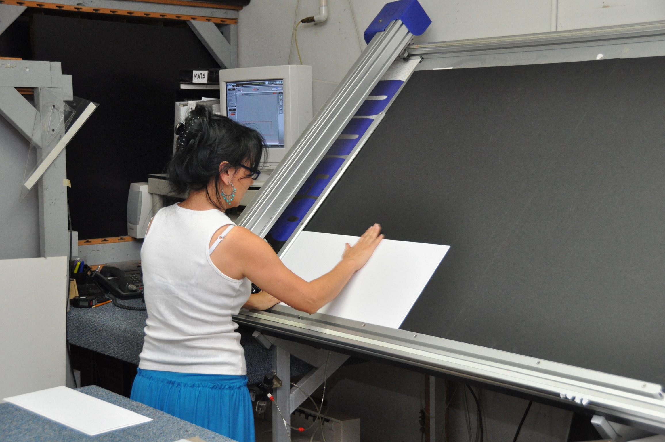 Cutting a custom mat on the computerized mat cutter.
