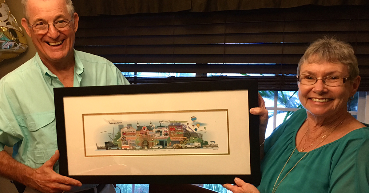 The Singers holding their framed Your Memory Lane anniversary street print.