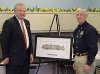 A formal presentation of a framed print on an easel