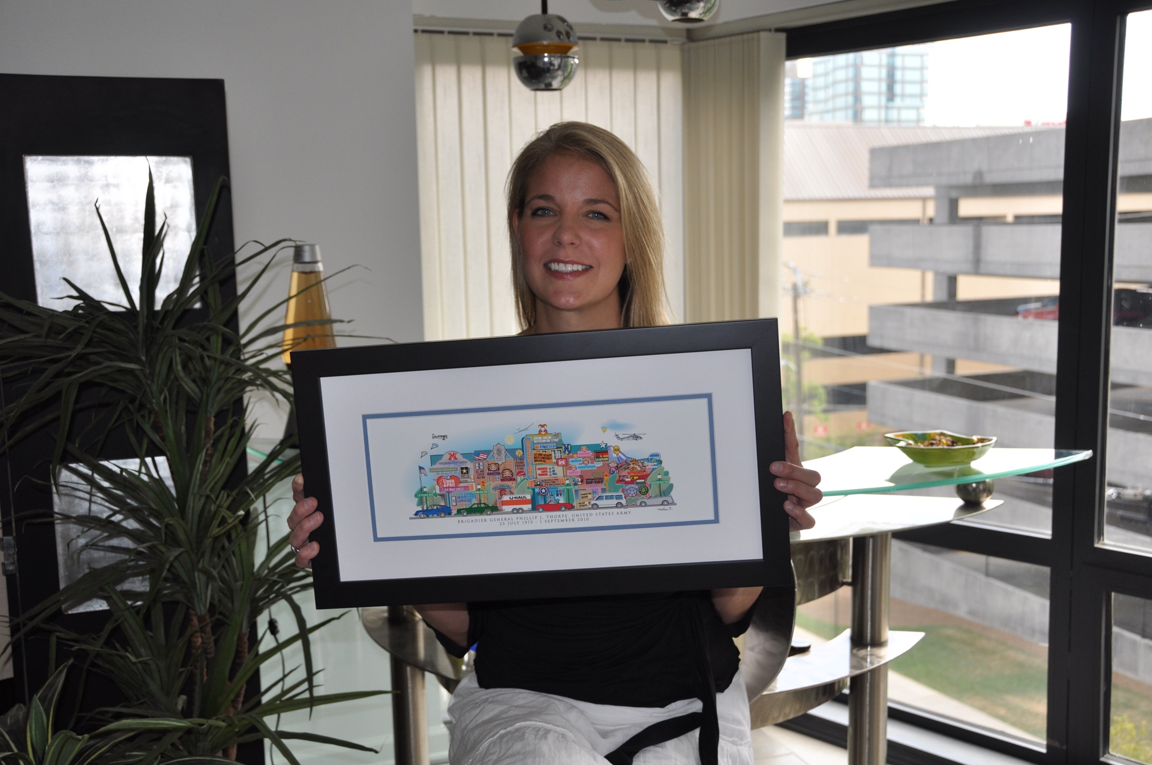 A woman holding her framed Your Memory Lane birthday street print.
