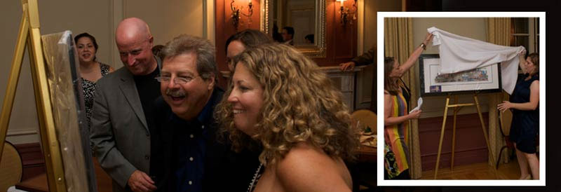 A group reacting to their print being unveiled at a gala