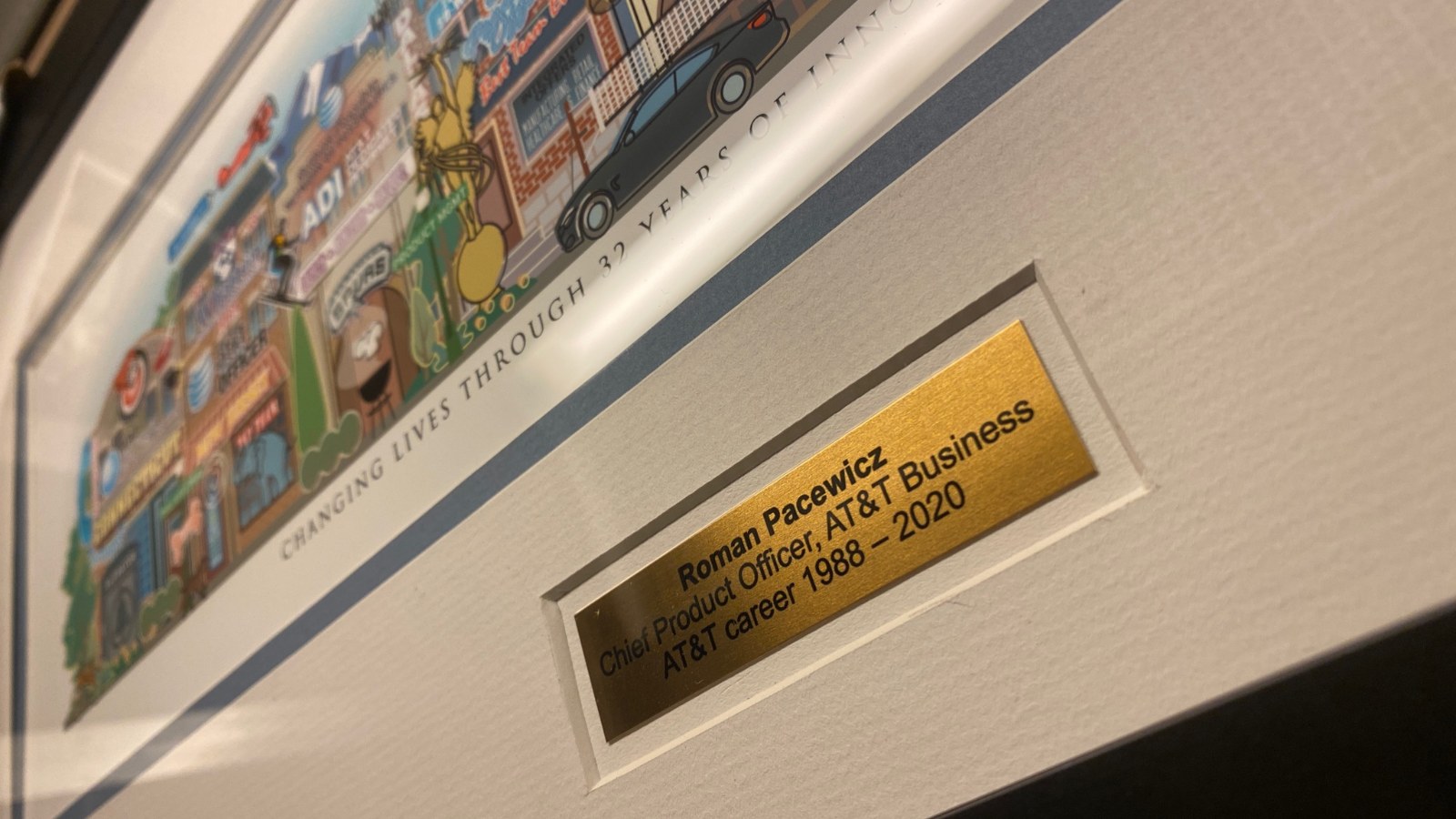 A Your Memory Lane corporate retirement print for Roman Pacewicz of AT&T Business, with an engraved brass plaque set into the mat.