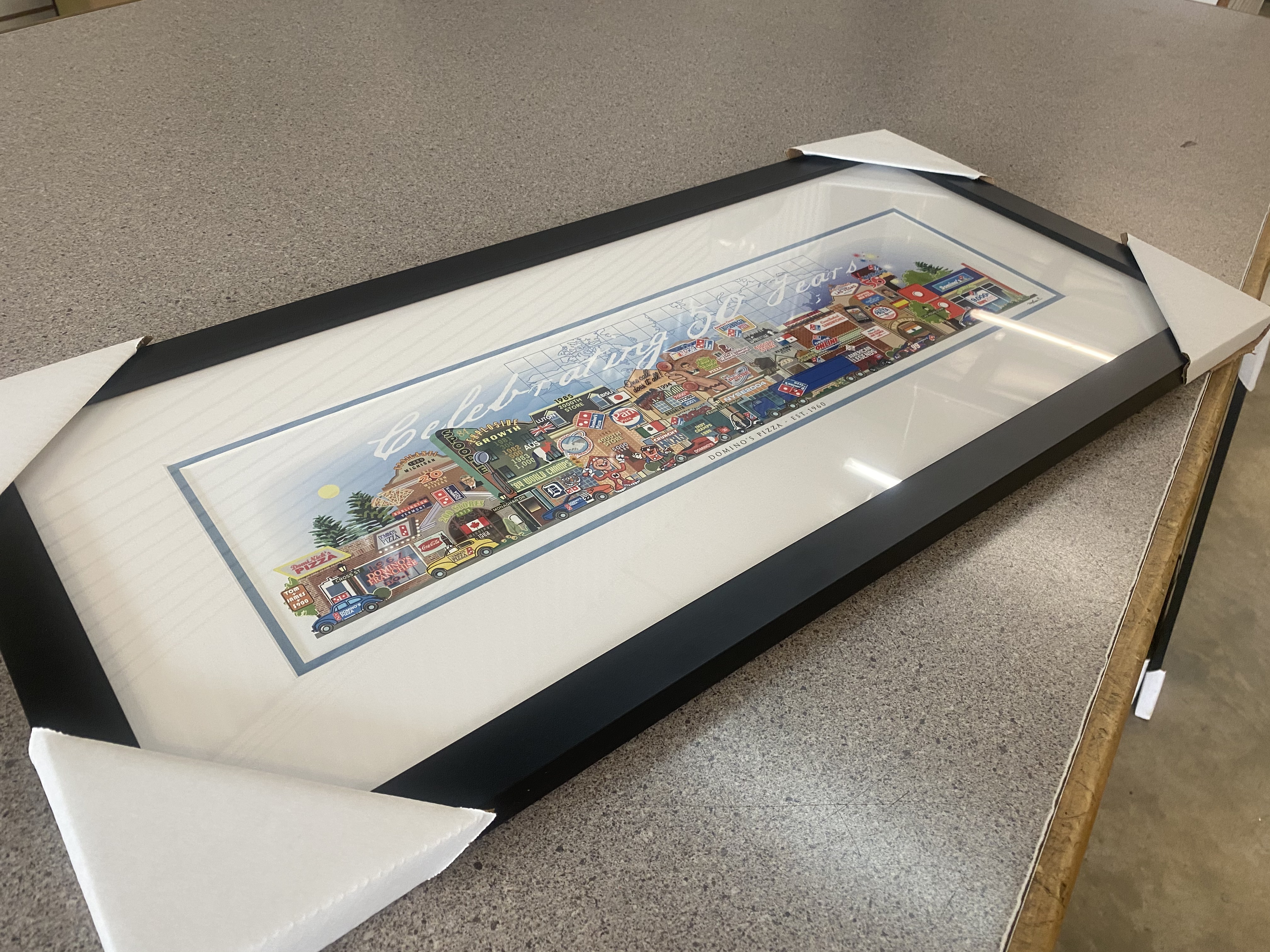 A finished, framed 50-year anniversary street print ready for delivery.