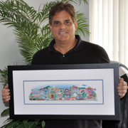 A man holding his 8-building street-scene print