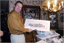 A man at home showing off his Your Memory Lane print