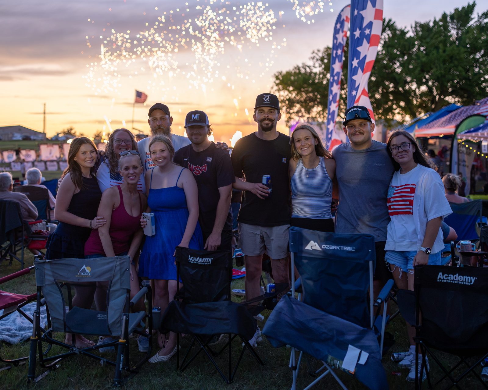 A group of friends posing as fireworks begin